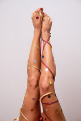 Women's legs are decorated like a Christmas tree. - 548201329