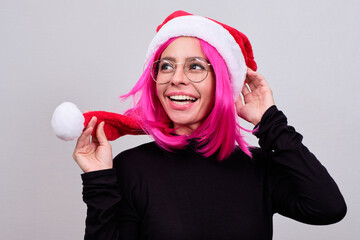 Woman with pink hair and a Christmas hat