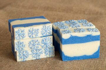 Original handmade soap with blue and white stripes and snowflake pattern.