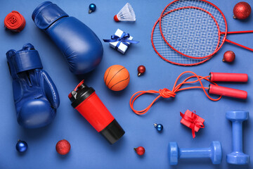 Sports equipment with Christmas balls and gifts on blue background