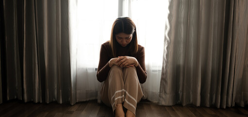 Obraz premium woman sit Depression Standing by window and anxiety Copy space. ..