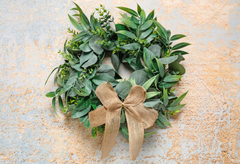 Stylish Christmas wreath on grunge background