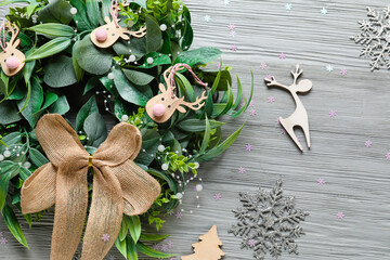 Beautiful Christmas wreath and decorations on grey wooden background, closeup