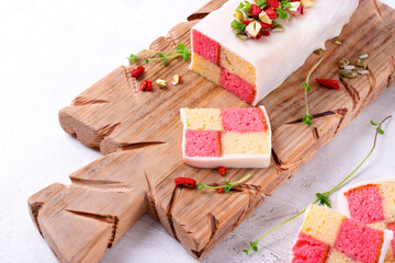 Battenberg cake, traditional British dessert with two-colored sponge cake wrapped in marzipan,...