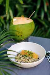 Plate with risotto at the table, outdoors