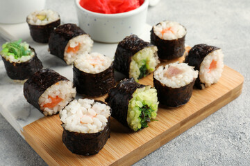 Tasty sushi rolls served on grey table, closeup