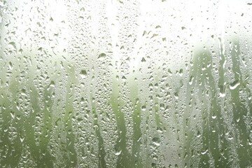 Window glass with raindrops as background, closeup