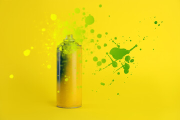 Fototapeta premium Can of spray paint and splatters on yellow background