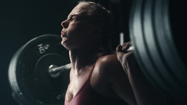 Portrait of Strong Sports Woman Overcoming the Workout Pain to Improve Her Physical Endurance. A Determined Female Athlete Trying To Beat her Personal Record by Training and Exercising. Close Up Shot
