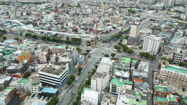 Aerial view of road traffic with surrounding complex buildings on the day, in Daegu city, Korea