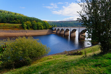 Fototapeta na wymiar Arched road bridge over the River Derwent at Ladybower reservoir.