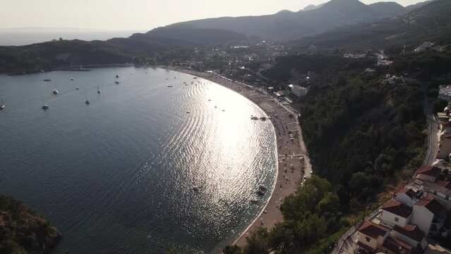 Scenic aerial pullback over popular Valtos beach and resort town of Parga, Epirus - hot travel destination in Greece