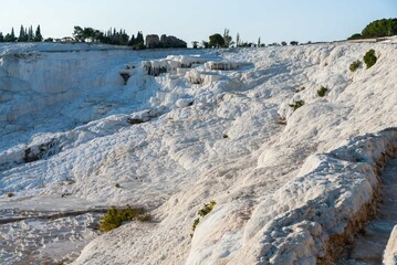 Pamukkale. City of Denizli. People walk on the upper terraces and admire natural pools and travertines of Pamukkale. Cotton castle in southwestern Turkey. Denizli, Turkey, September 5, 2007