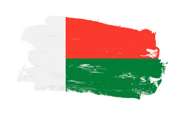 Stroke brush painted distressed flag of madagascar on white background
