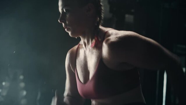 An Athletic Blond Woman Working out Using the Running in Place Exercise. Professional Track Runner Training to Break a Record by Exercising Hard. Tracking Slow Motion Shot