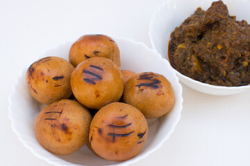 Litti with chicken. It is popular in Bihar, Uttar Pradesh and Jharkhand. White background