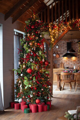 Christmas tree in the chalet. Beautiful New Year's interior in the chalet. Festive mood.