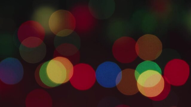 Multicolored flickering Christmas lights out of focus. Congratulation, postcard. Background, insert captions, congratulations. Video footage intro copy space. UHD 4K.