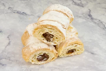 Raamstickers Closeup of puff pastry chocolate cream horns with icing sugar. © Carlos Valle/Wirestock Creators