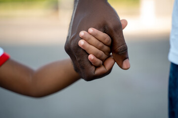 Family of two people walking hand in hand