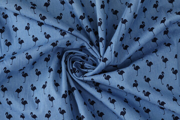 Wavy fabric with black flamingo print on blue background