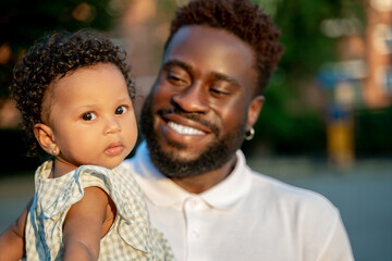 Pleased parent admiring his cute little daughter