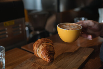 Man drinking morning coffee in cafe. Closeup. 