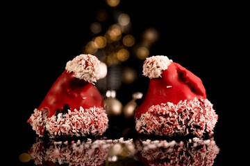 Christmas cakes formed like Santa Claus's hat - bokeh lights background