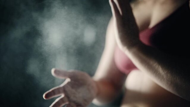 Close Up, Slow Motion Shot: Female Weightlifter Dusting off Chalk from her Palms. An Athletic Woman Putting Chalk on her Hands to Start Exercising, Working Out, Training With Weights