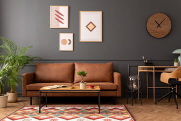 Creative composition of living room interior with mock up poster frame, brown sofa, wooden desk, coffee table, clock, flower in flowerpot, patterned rug and personal accessories. Home decor. Template.
