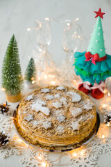 Honey cake Christmas cake. Christmas cake with Christmas decorations. Vertical photo. Christmas tree with cookies.