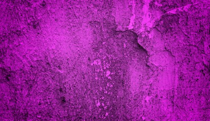 A textured purple concrete wall with a prominent vertical crack. 