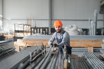 Factory worker measures the metal profile