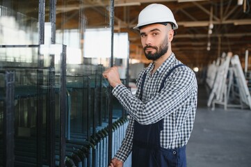 Happy Professional Heavy Industry Engineer Worker Wearing Uniform, and Hard Hat in a Steel Factory. Smiling Industrial Specialist Standing in a Metal Construction Manufacture