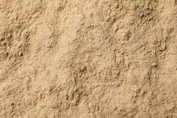 Heap of buckwheat flour as background, top view