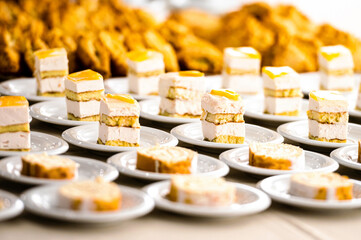 rows of cake desert on white dish row on table for break after meeting