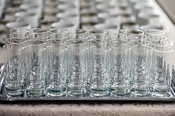 abstract background of many rows of glass glasses and cups of coffee or tea, selective focus