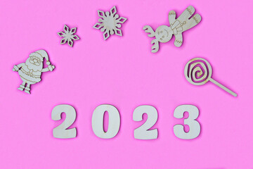 Happy New year 2023 number wood object on pink background and copy space - new year celebrate and business resource concept - marketing resource design mock up.