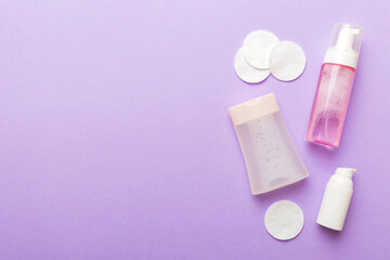 Micellar cleansing water and discs to remove cosmetics and cleanse the skin on colored background. Copy space top view