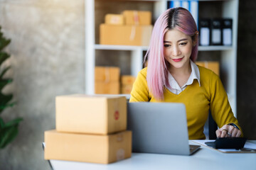 Young entrepreneur women working at home about online business. Business owner women using calculator and smart phone working at home.