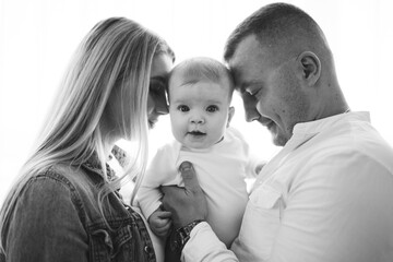 Portrait of a young family in the studio