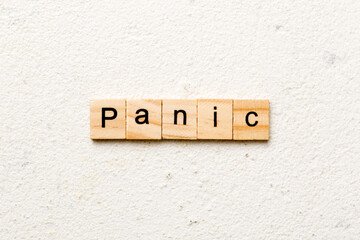 panic word written on wood block. panic text on table, concept