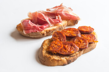 Slice of bread with chorizo and serrano ham
