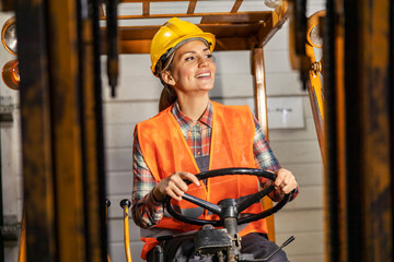 A female forklift driver is doing logistics in facility.