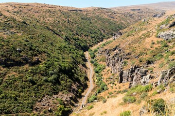 Fototapeta premium View of a country road in a gorge in the Caucasus mountains.