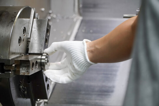 5-axis CNC lathe operator turning workpieces in collet chuck,Production of electric vehicle parts