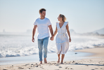 Couple, beach and holding hands for love, walk or care in relationship bonding together in the...