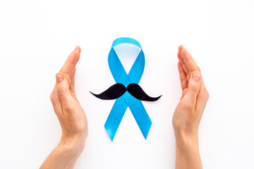 Awareness blue ribbon with a paper mustache. Symbol of prostate cancer