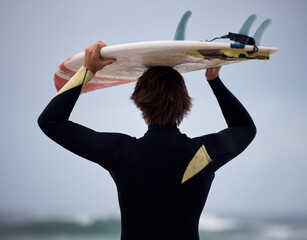 Surfer, surfboard and surfing ocean on waves for fitness exercise, leisure and water sport training...