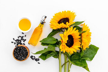 Yellow sunflowers with cooking oil and black seeds. Food background